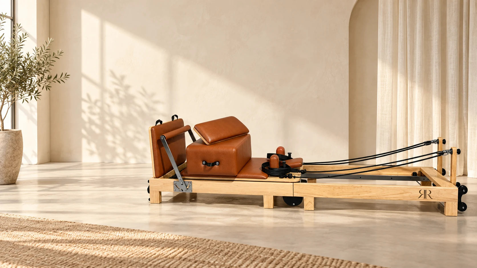Reset & Reform natural-oak Pilates reformer in a warm studio
